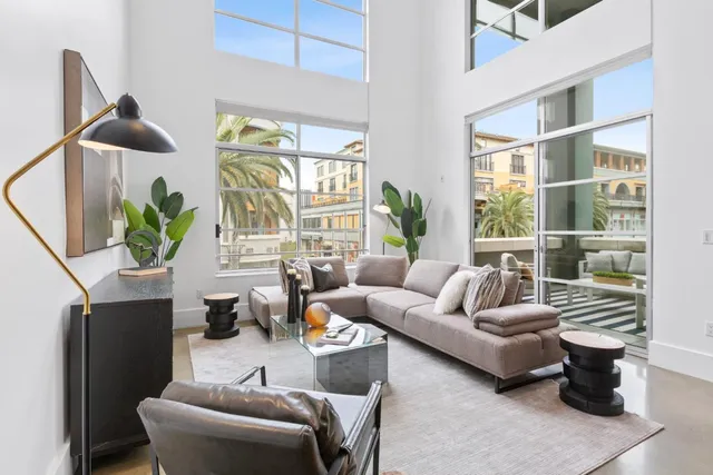 a living room with furniture and a potted plant