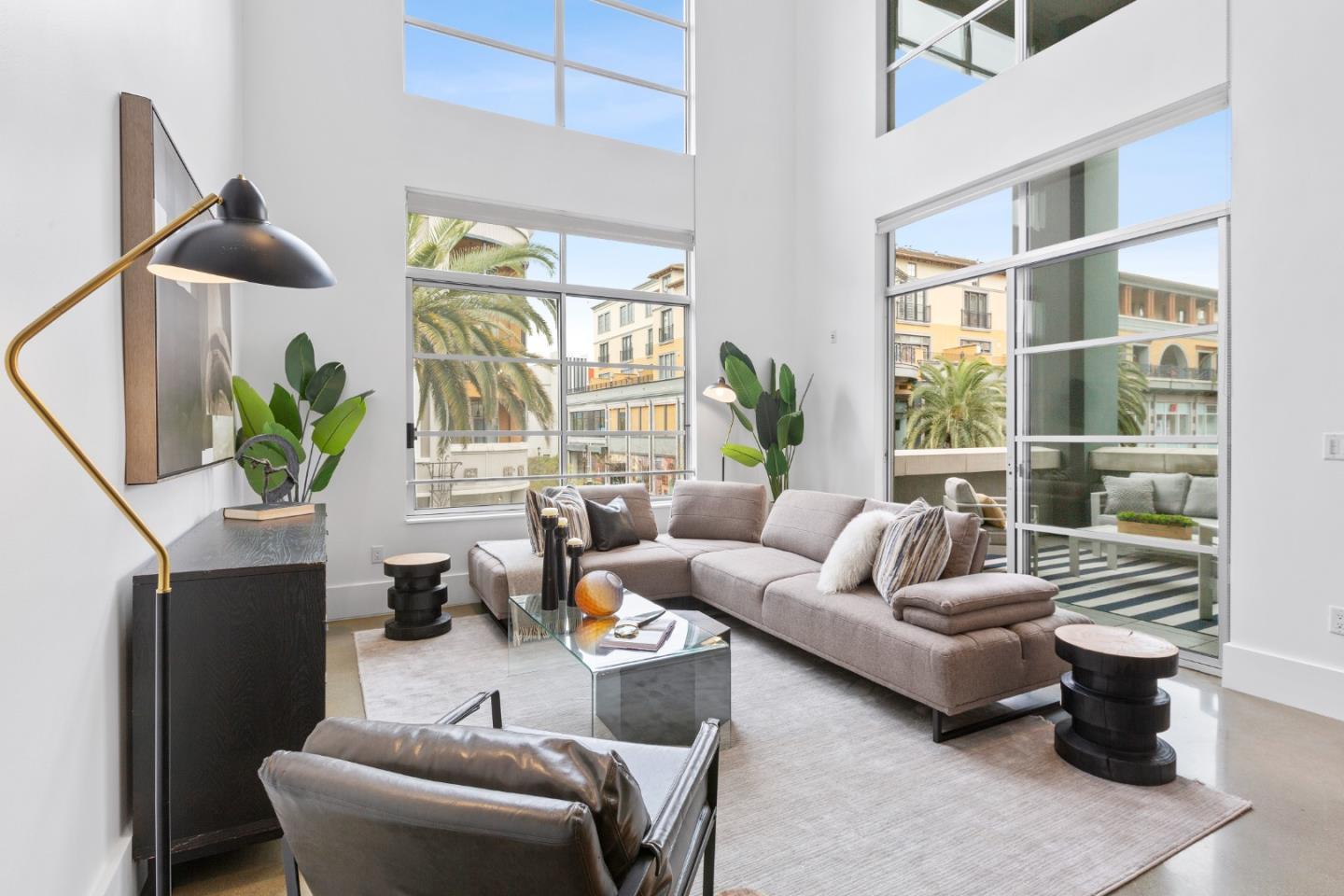 a living room with furniture and a potted plant