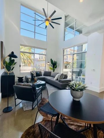 a living room with fireplace furniture and a potted plant