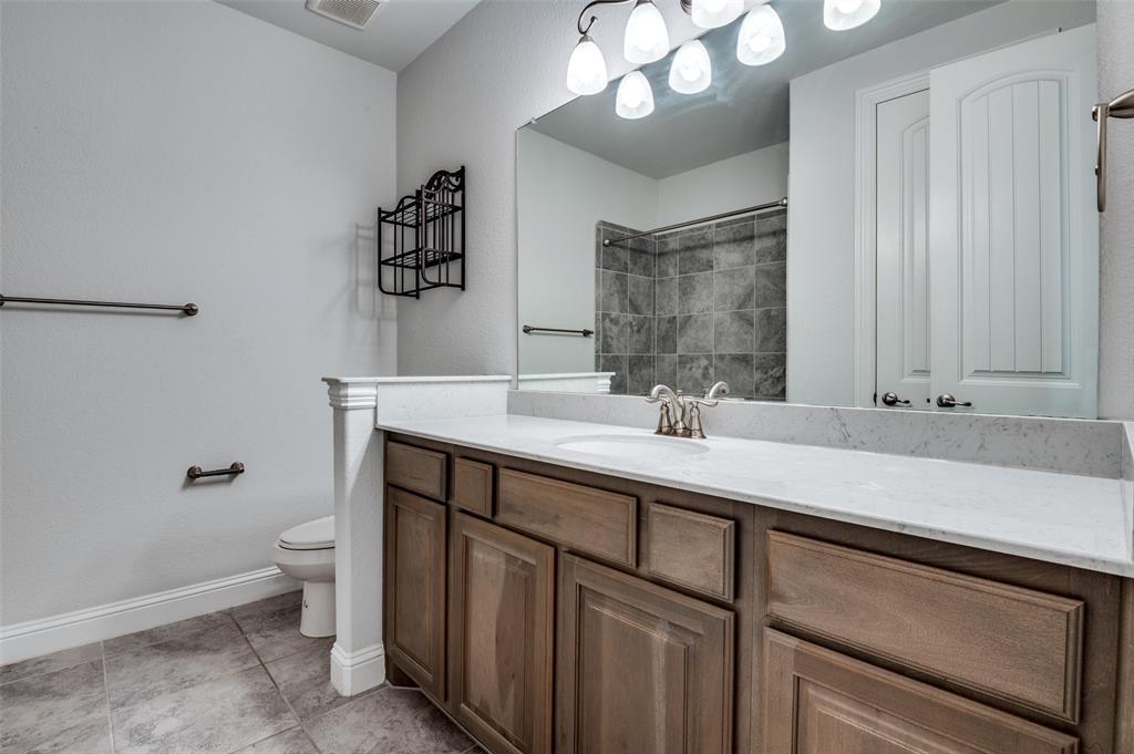426 Summer Grove Drive Midlothian, TX 76065 - Photo 18 of 25 a bathroom with a sink a toilet and a large mirror