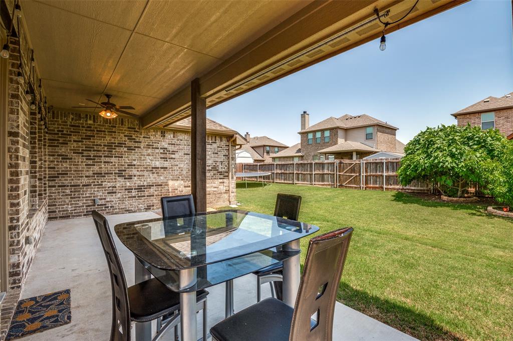 426 Summer Grove Drive Midlothian, TX 76065 - Photo 23 of 25 a view of an outside dining space with furniture