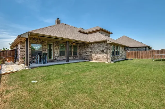 a view of yard with swimming pool and green space