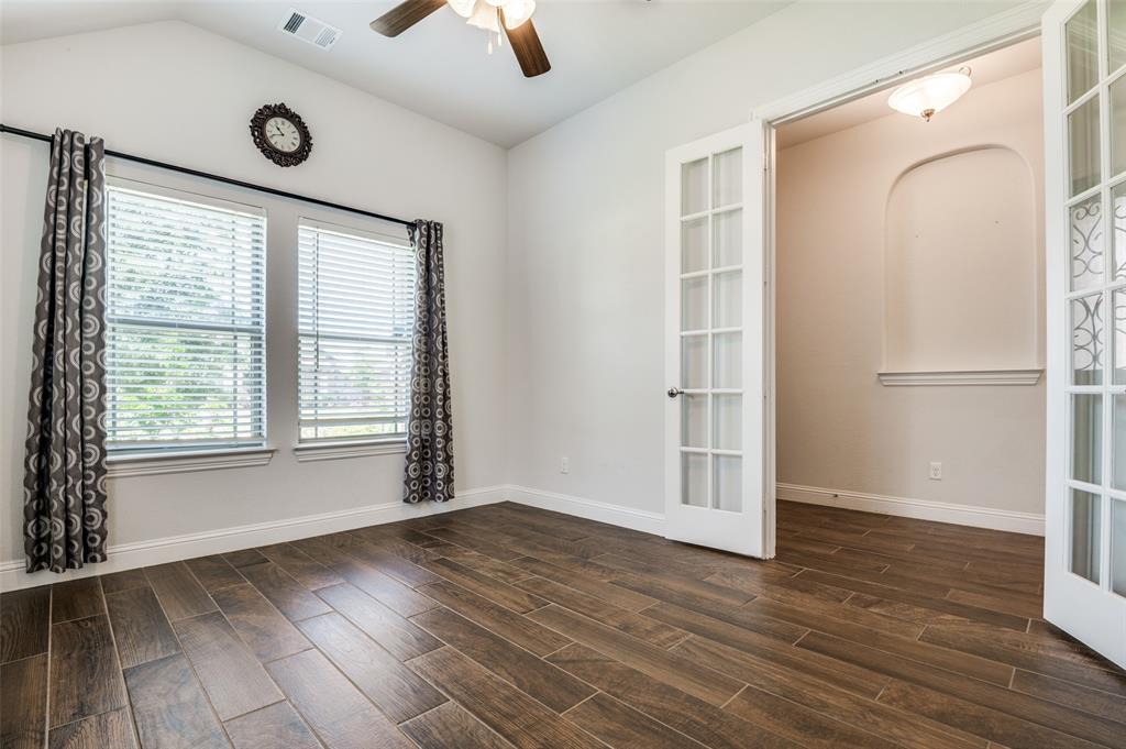 426 Summer Grove Drive Midlothian, TX 76065 - Photo 4 of 25 an empty room with wooden floor and windows