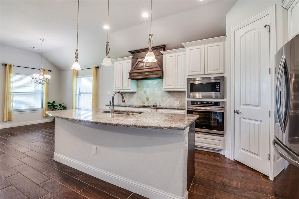 426 Summer Grove Drive Midlothian, TX 76065 - Photo 7 of 25 a kitchen with stainless steel appliances granite countertop a sink a stove and a refrigerator