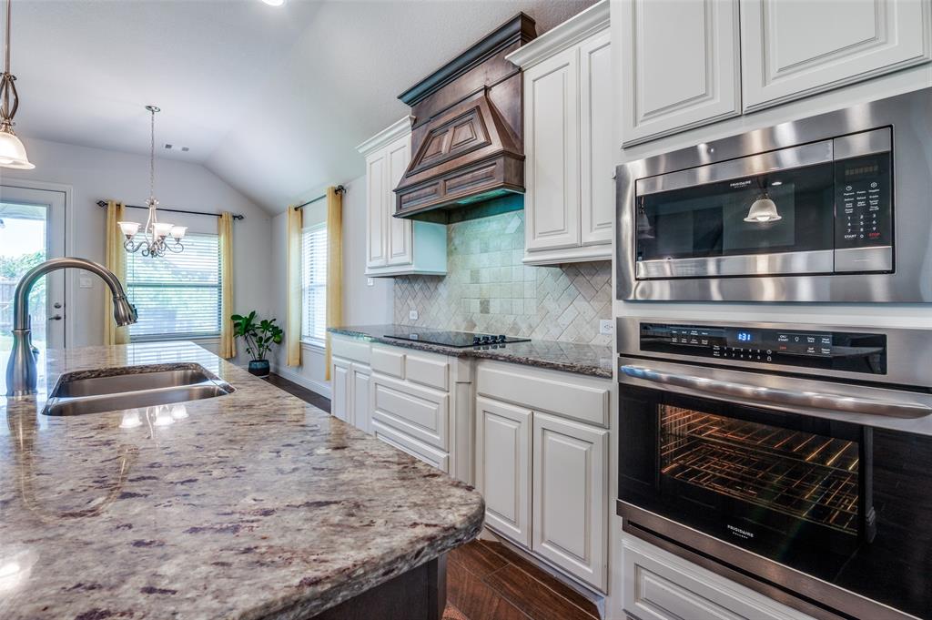 426 Summer Grove Drive Midlothian, TX 76065 - Photo 8 of 25 a kitchen with stainless steel appliances granite countertop a stove microwave and cabinets