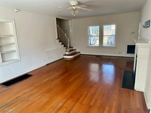 wooden floor in an empty room with a window
