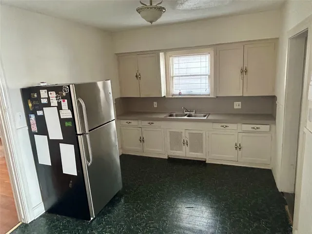 a kitchen with stainless steel appliances granite countertop a refrigerator a sink and a stove