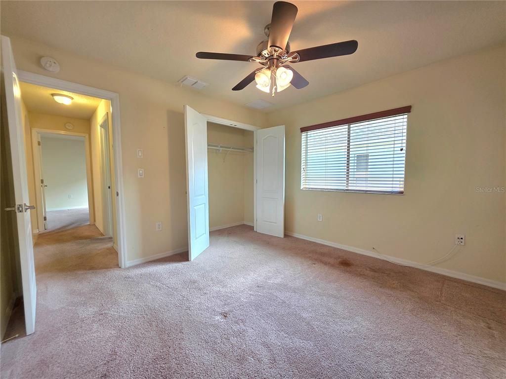 4284 High Ridge Avenue Spring Hill, FL 34609 - Photo 33 of 40 an empty room with chandelier fan and windows