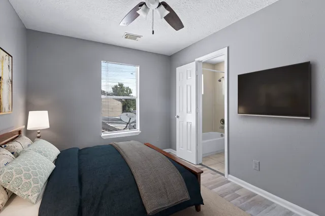 a bedroom with a bed and a flat screen tv