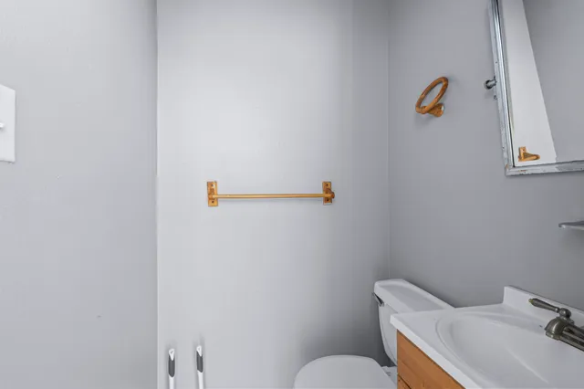 a bathroom with a sink a toilet and a mirror