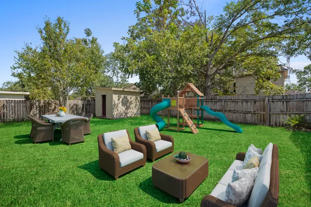 a view of a couches in a patio with a yard