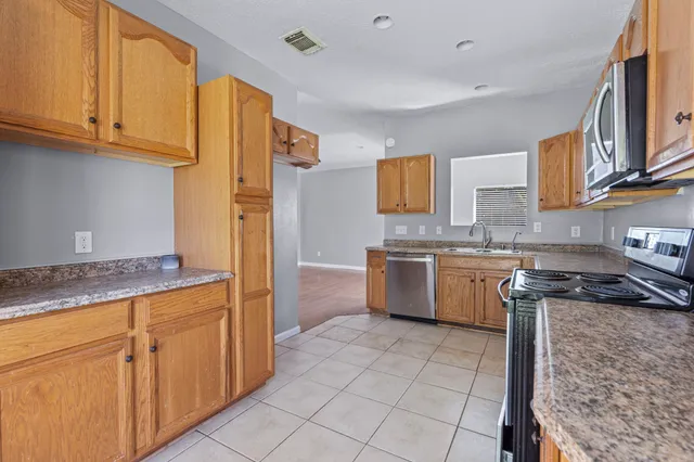 a kitchen with a sink stove and cabinets