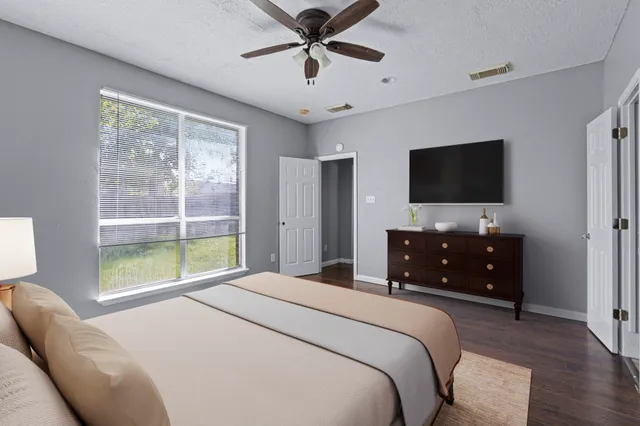 a bedroom with a bed and a flat screen tv