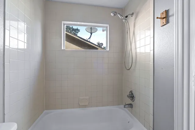 a bathroom with a bathtub and shower
