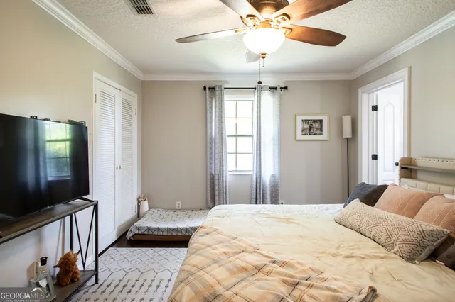 a bathroom with a toilet and a shower curtain