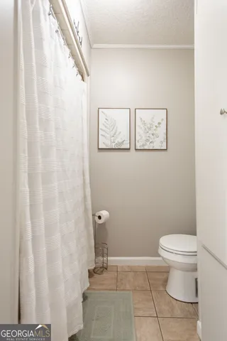a view of a livingroom with furniture and a potted plant