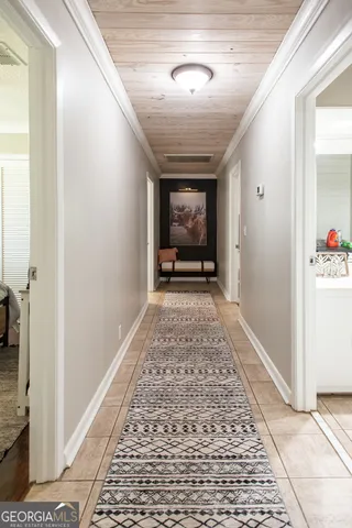 a large kitchen with stainless steel appliances granite countertop a stove top oven a sink a dining table and chairs