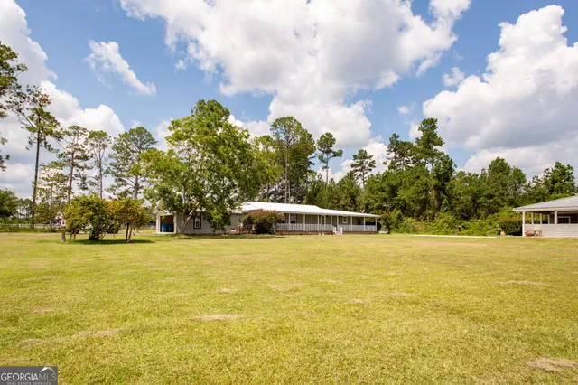 a view of a house with swimming pool and sitting area