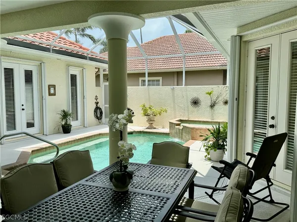 a view of a patio with table and chairs
