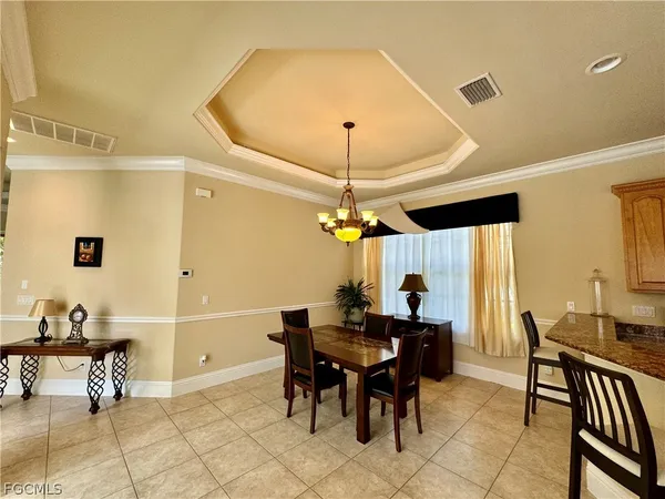 a dining room with furniture and window