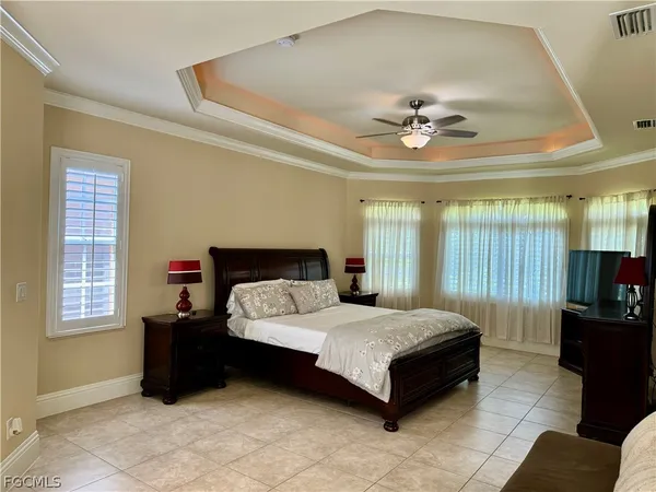 a bedroom with a bed couch and window
