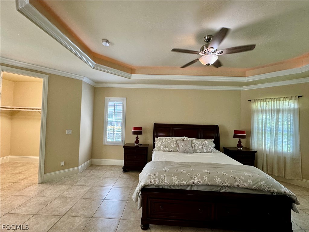 1740 Ludlow Road Marco Island, FL 34145 - Photo 28 of 47 a bedroom with a bed and a chandelier