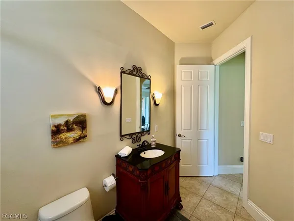 a bathroom with a sink mirror and toilet