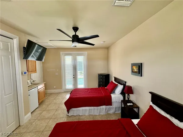 a bedroom with a bed and a chandelier