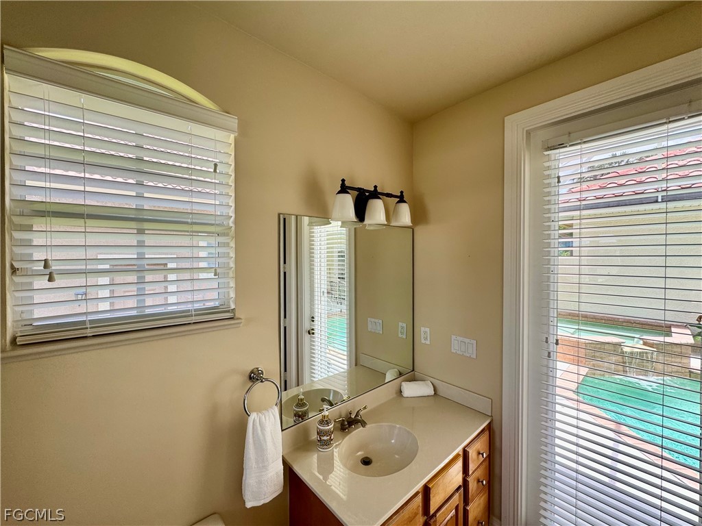 1740 Ludlow Road Marco Island, FL 34145 - Photo 42 of 47 a bathroom with a sink a mirror and a window