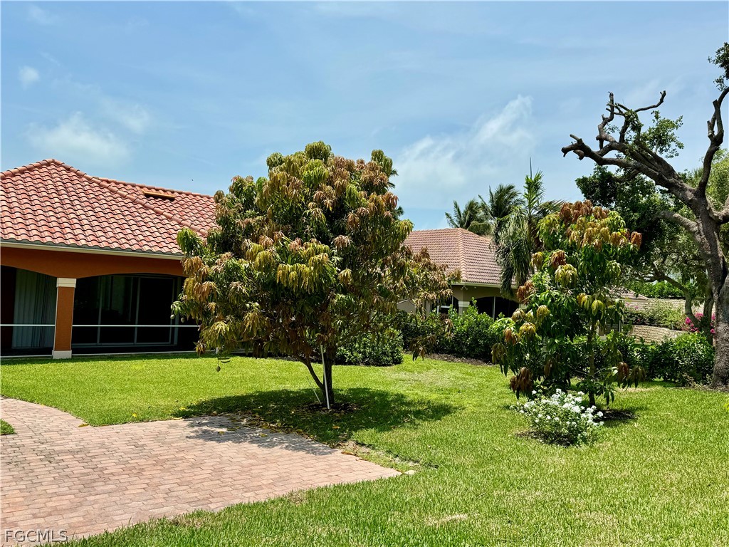 1740 Ludlow Road Marco Island, FL 34145 - Photo 8 of 47 a front view of a house with a yard and green space