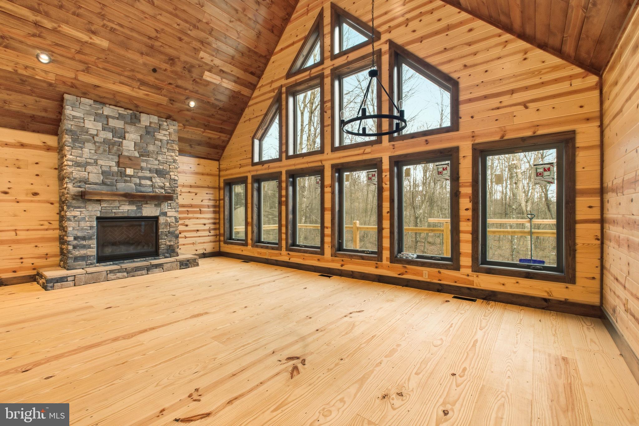 45 Nature Run McHenry, MD 21541 - Photo 2 of 39 an empty room with wooden floor and fireplace