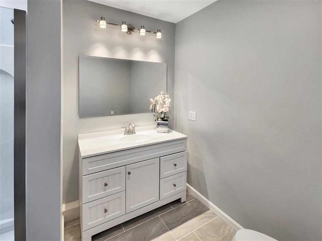 144 Rounds Street New Bedford, MA 02740 - Photo 12 of 20 a bathroom with a sink and a mirror