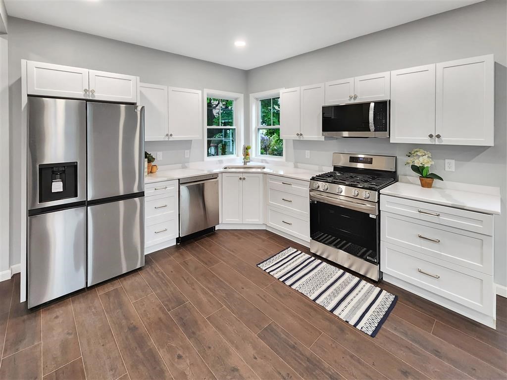 144 Rounds Street New Bedford, MA 02740 - Photo 6 of 20 a kitchen with stainless steel appliances a stove a sink and a refrigerator