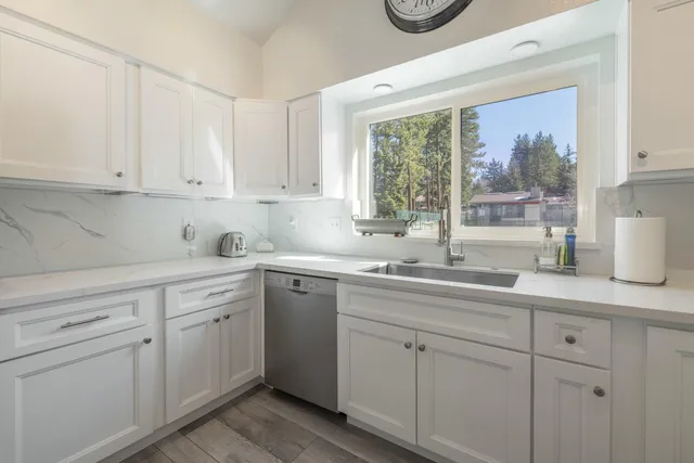 a kitchen with white cabinets and white appliances