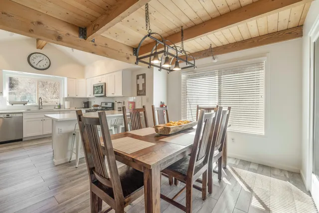 a view of a dining room with furniture and window