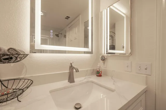a bathroom with a sink and a window