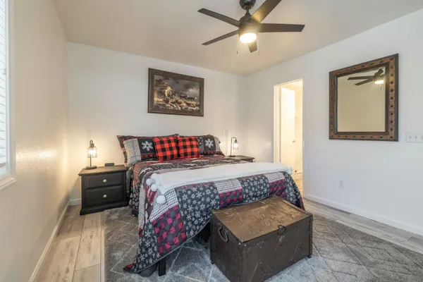 a bedroom with a bed and a chandelier