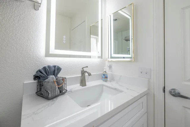 a bathroom with a sink and a mirror