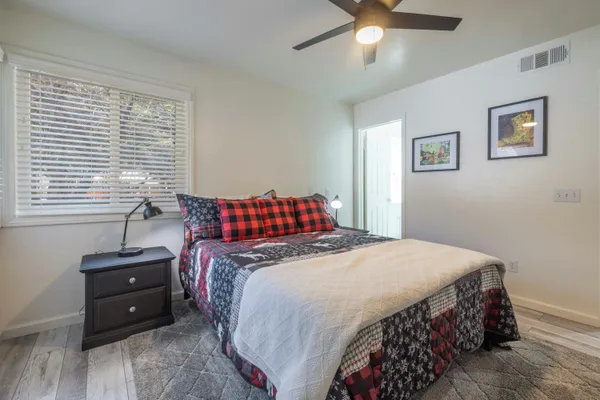 a bedroom with a bed and a chandelier