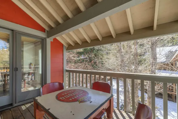 a view of a room with furniture and wooden floor