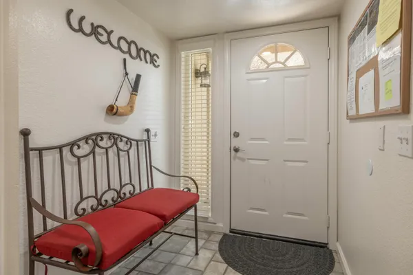a view of a hallway with windows and stairs