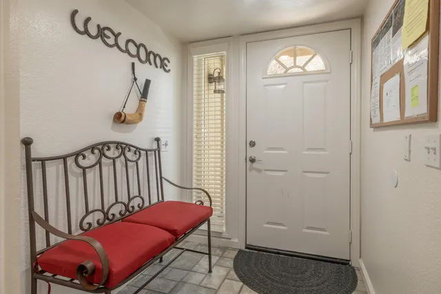 a view of a hallway with windows and stairs