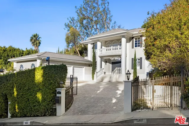 a front view of a building with a tree