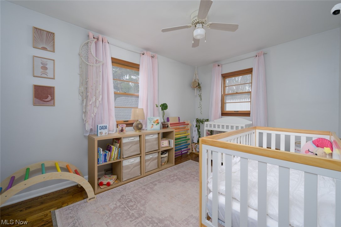 1165 Meadowview Road Kent, OH 44240 - Photo 16 of 40 Bedroom with a crib, light hardwood / wood-style flooring, and ceiling fan
