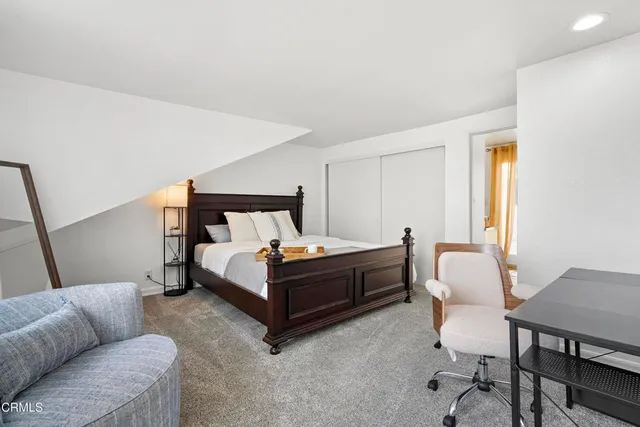 a bedroom with a bed and a couch