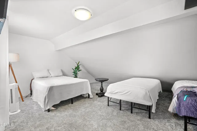 a bed room with a bed and a chair