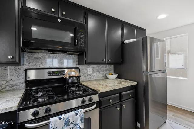 a kitchen with a stove and a microwave