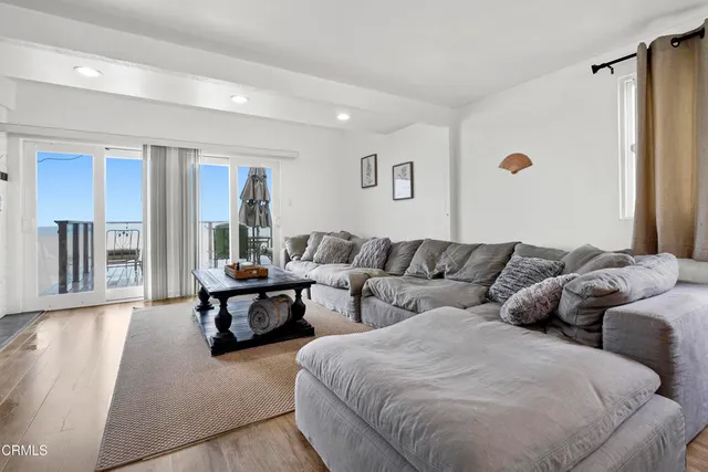 a living room with couches and a night stand