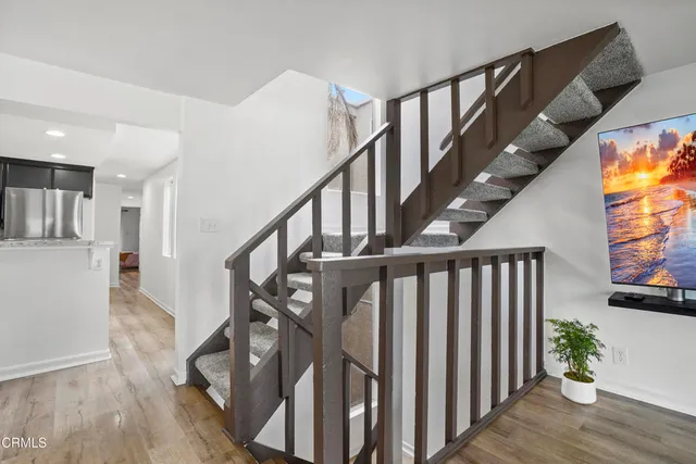 a view of entryway with wooden floor and stairs