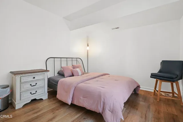 a bedroom with a bed and a chair